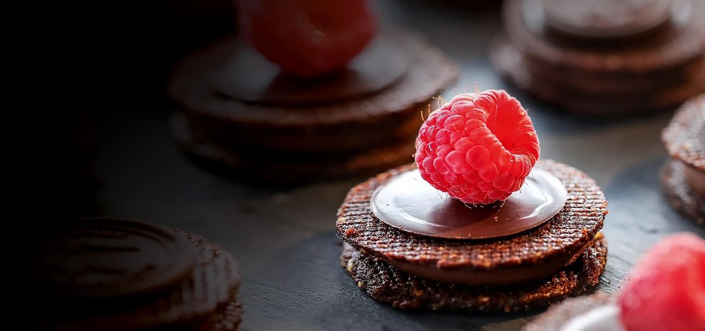 A variety of cookies arranged together, featuring different shapes, colors, and toppings