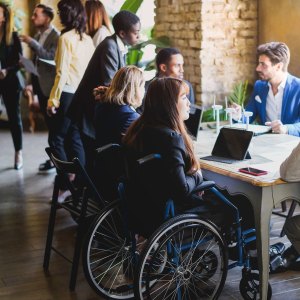 Multiracial business people working on sustainable innovation project - Focus on asian woman sitting on wheelchair